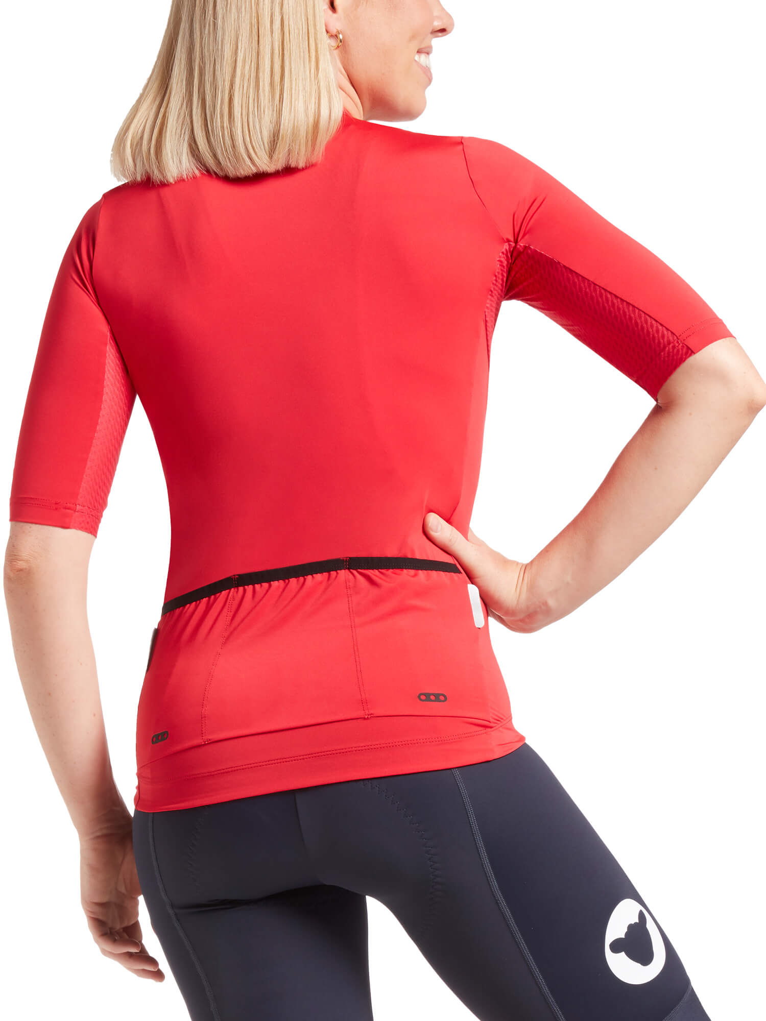 Woman wearing Black Sheep Cycling Essentials TEAM Jersey SS22- Women's shown from back with three rear pockets and fitted design