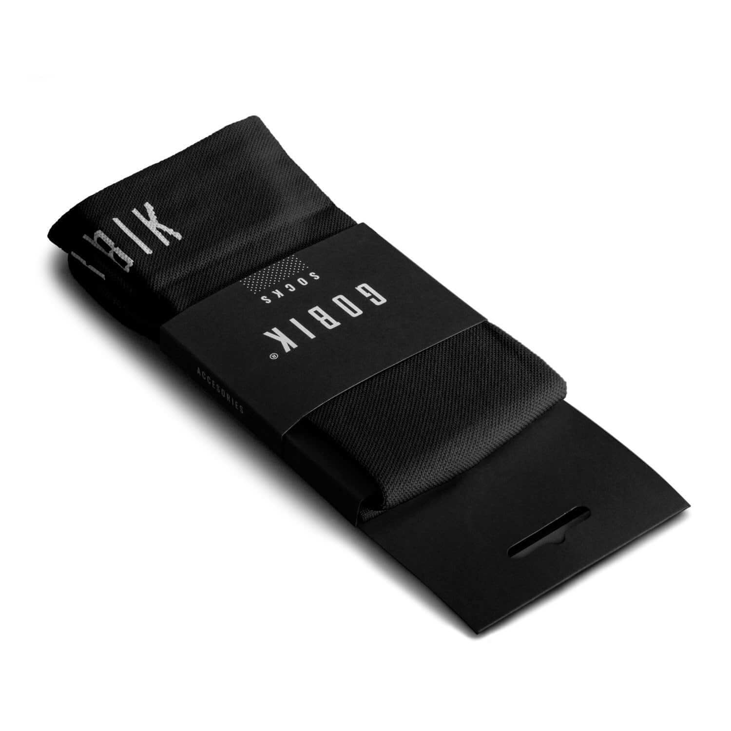 GOBIK Pure Black Socks folded with packaging showing brand name, designed for moisture wicking and comfort.