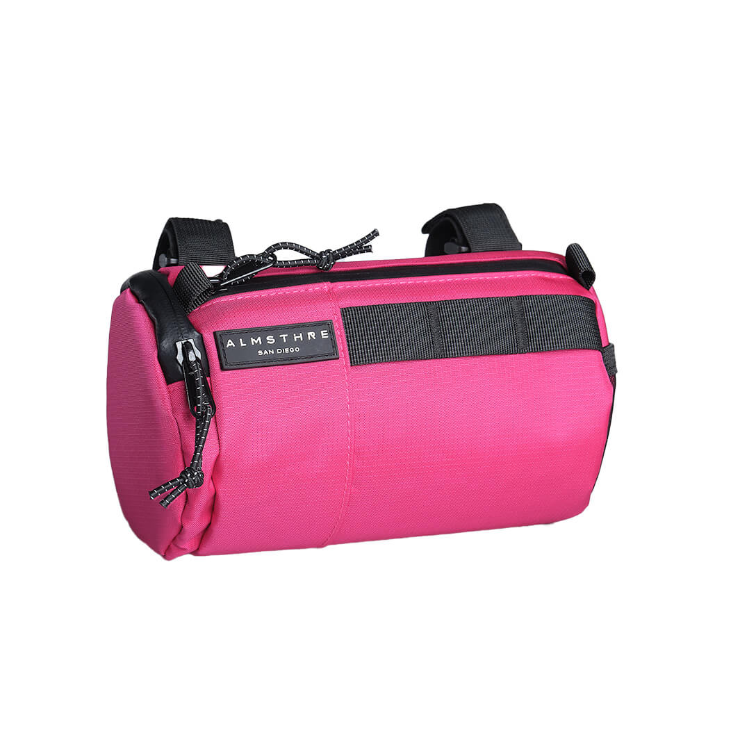 ALMSTHRE Signature Bar Bag in bright pink with durable fabric and secure handlebar straps for adventure-ready storage