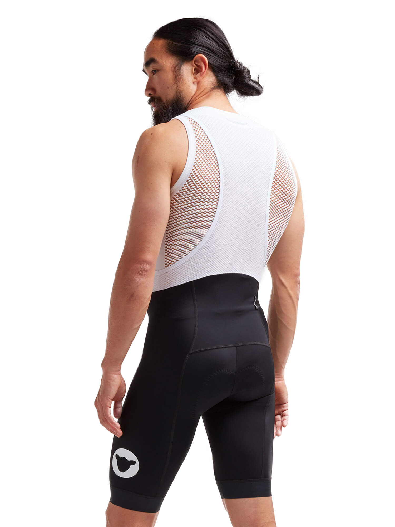 Rear view of a man wearing Black Sheep Cycling Essentials TEAM Bib - Men's with mesh upper and black padded shorts designed for durability
