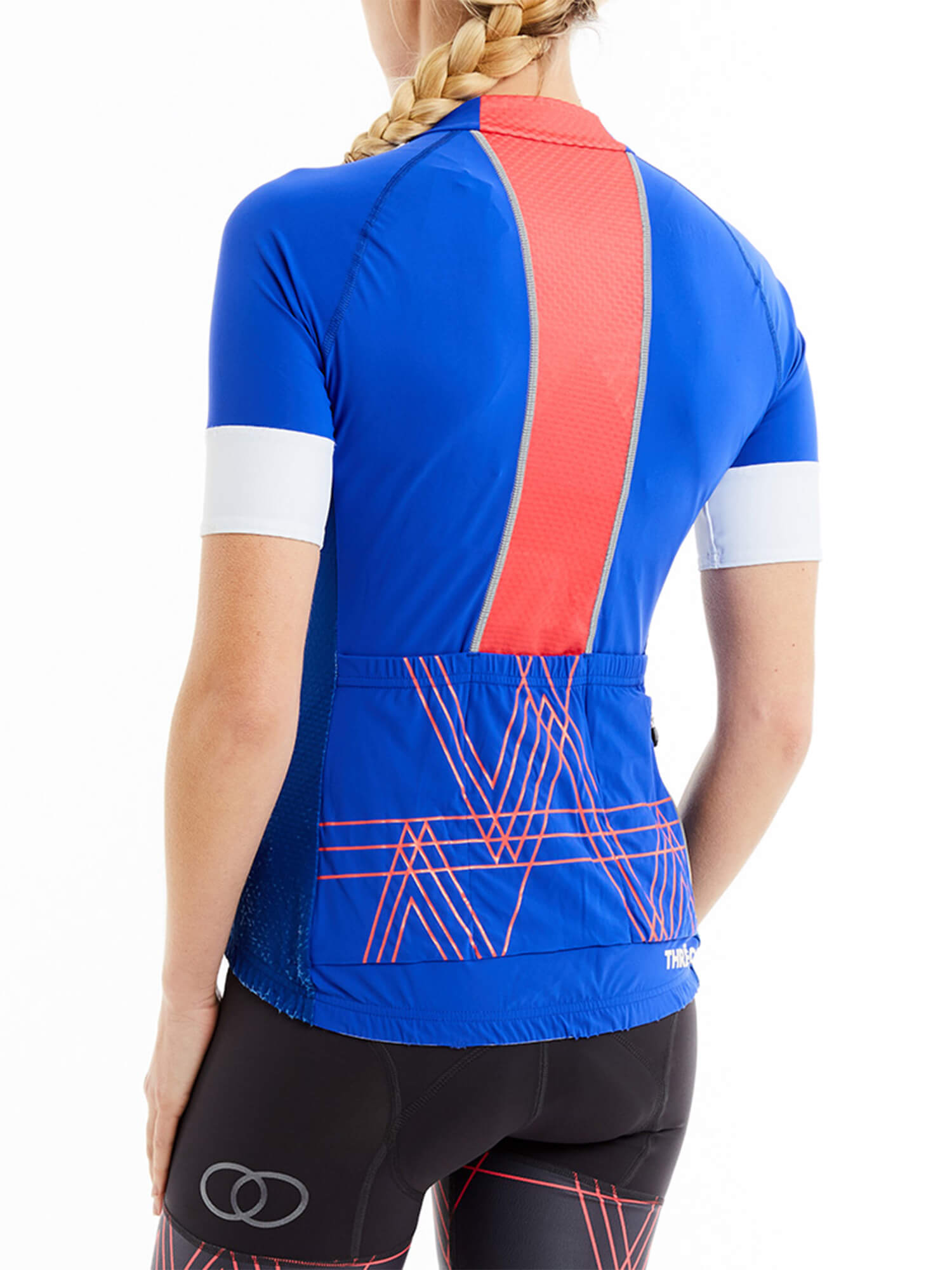 Rear view of woman wearing Threo Regent's Park Jersey in blue with red pattern and mesh back panel against white background