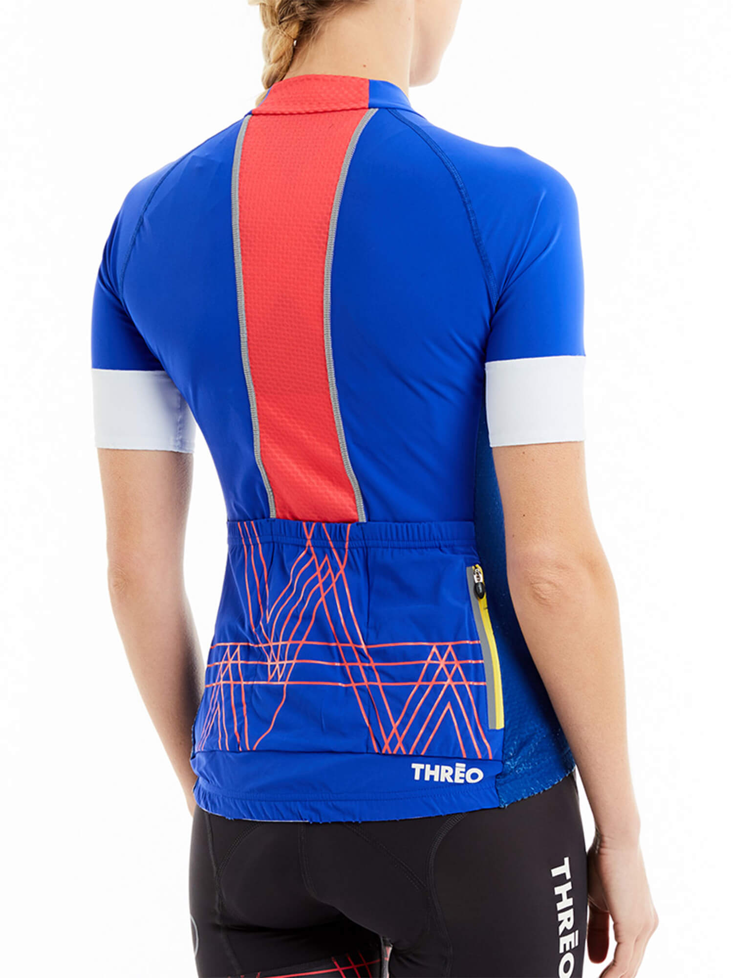 Back view of a woman wearing Threo Regent's Park Jersey in blue with red accents and rear pockets for cycling storage