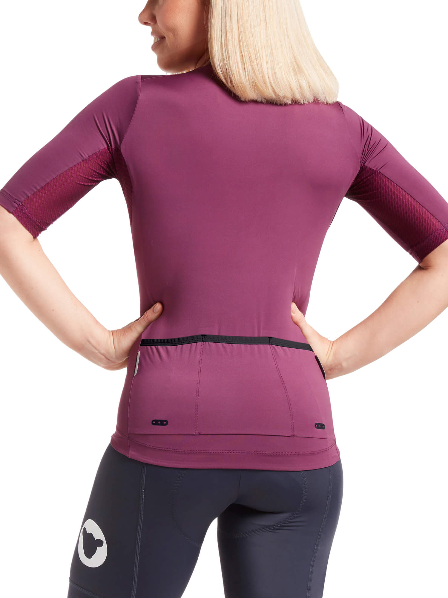 Back view of woman wearing Black Sheep Cycling Essentials TEAM Jersey SS22- Women's in plum with rear pockets and fitted sleeves