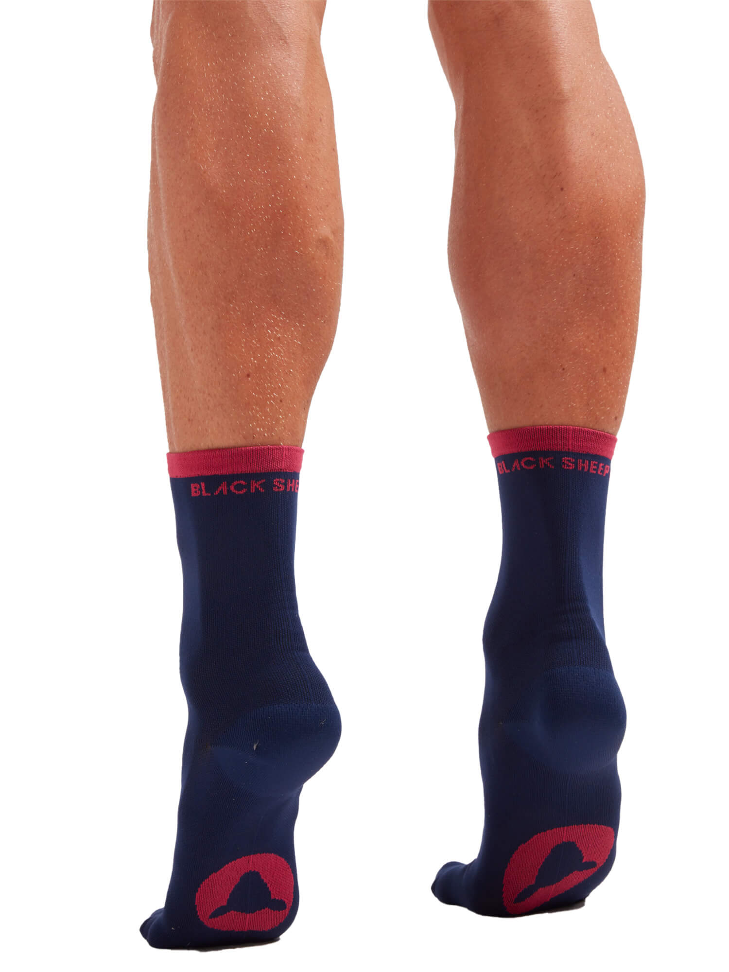 Black Sheep Cycling Perfect Crew Stripe Socks in navy with red accents shown on a model’s legs from behind