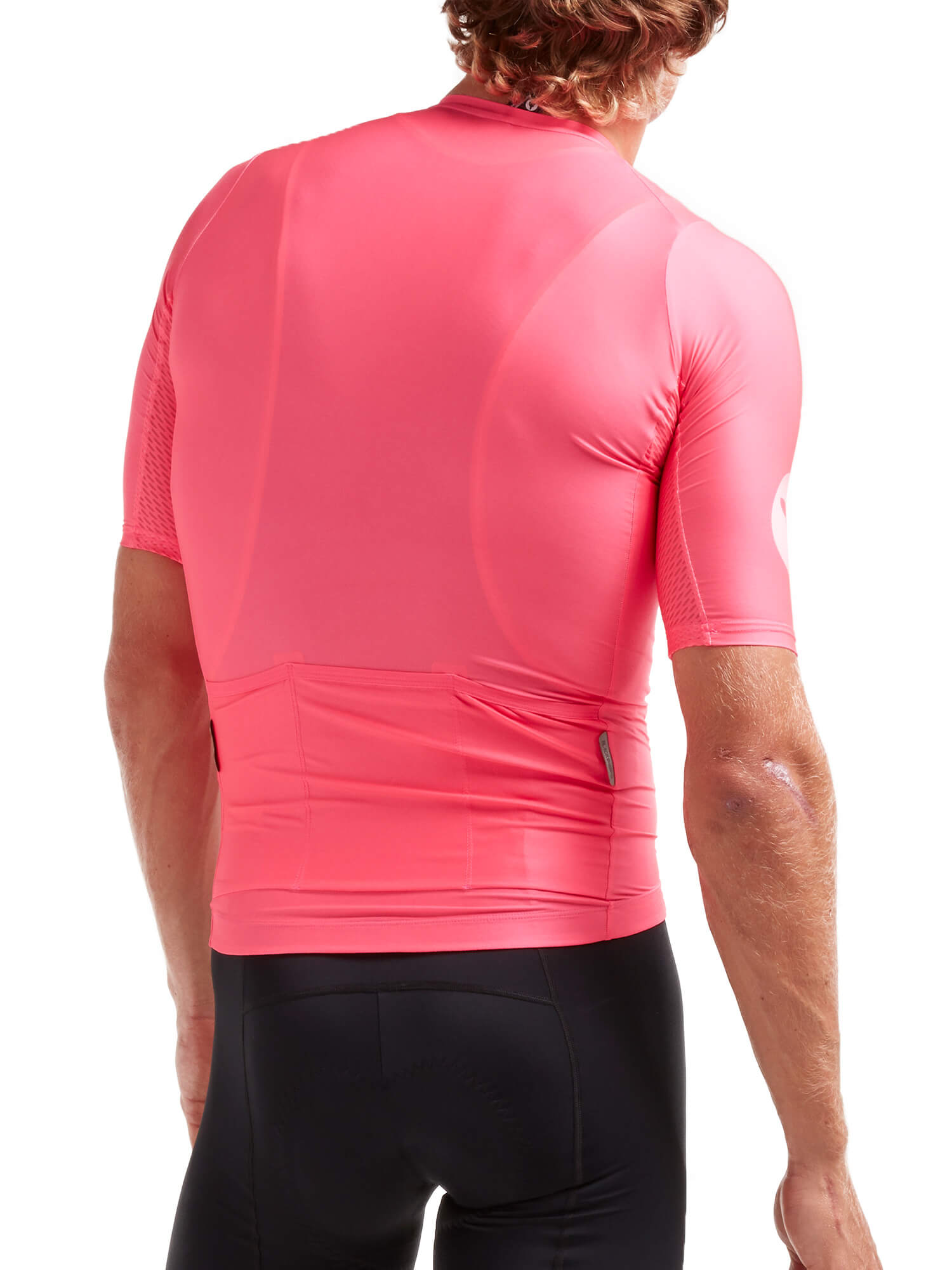 Rear view of a man wearing Black Sheep Cycling Essentials TEAM Jersey - Men's in bright pink with fitted design and rear pockets.