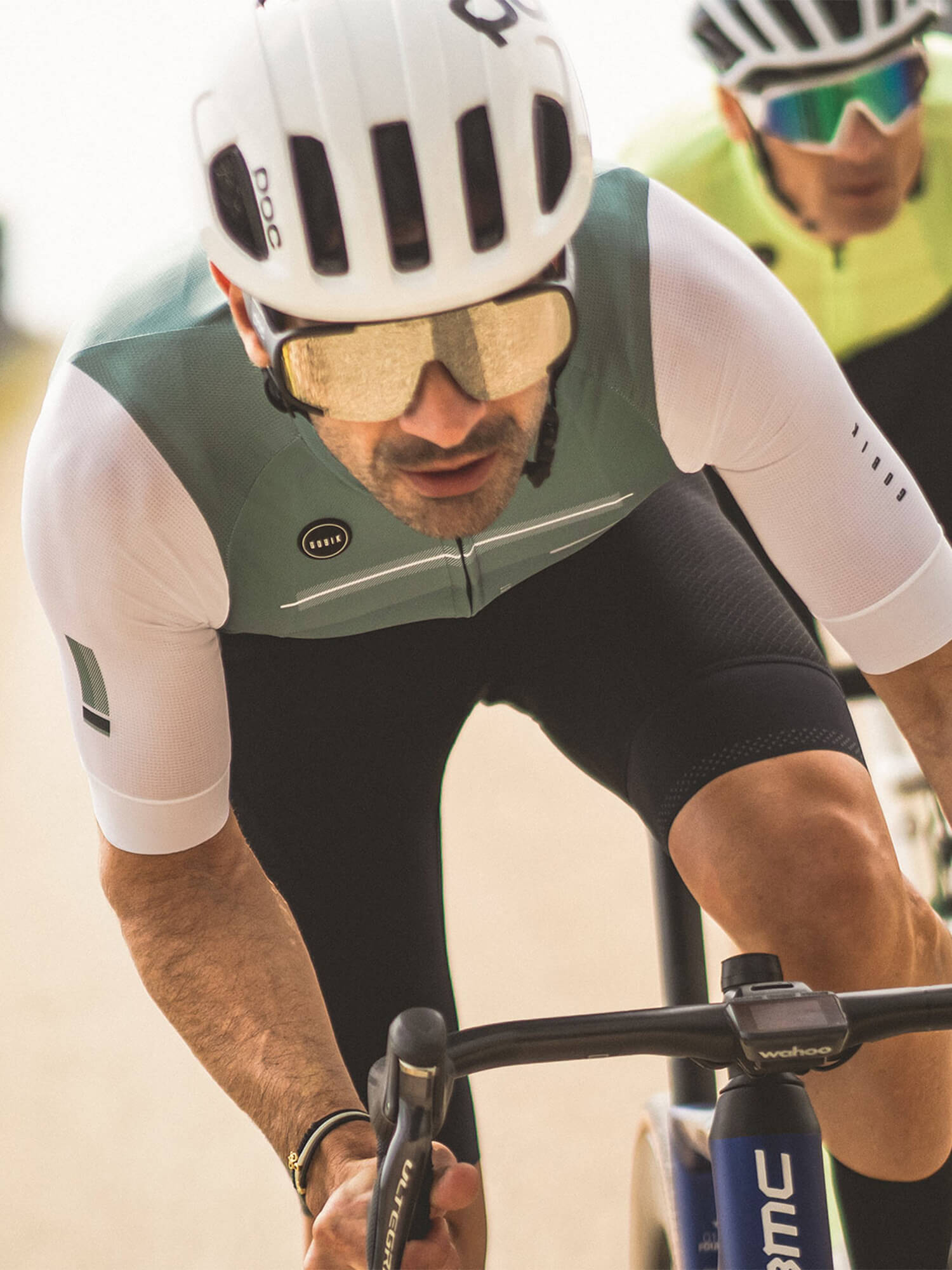 Cyclist wearing GOBIK CX Pro Unisex Short Sleeve Jersey - SS21, riding intensely with helmet and sunglasses